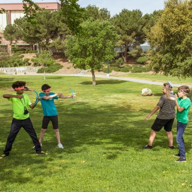 People Playing Soccer on Green Grass Field