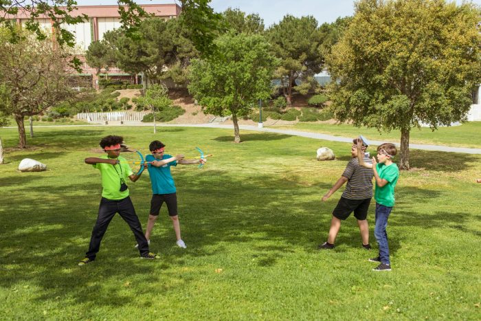 People Playing Soccer on Green Grass Field